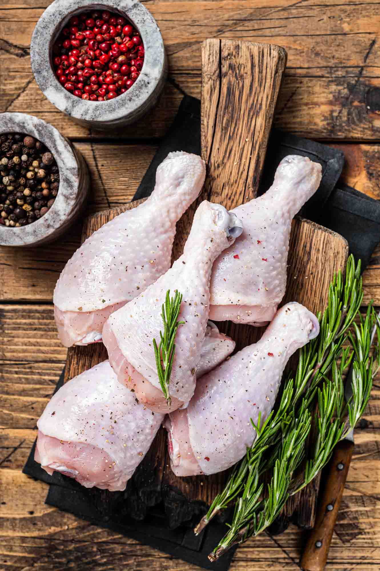 Chicken drumsticks legs with skin, raw poultry meat